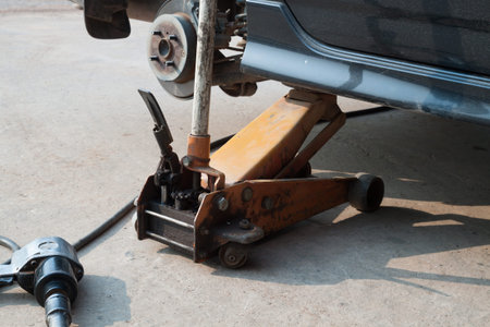 Changing car tire with hand jack