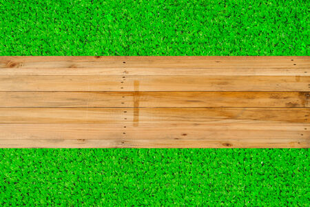 Wood texture on green grass backgroundの写真素材