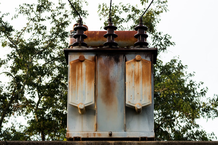 Old Electric transformer on electric poleの写真素材