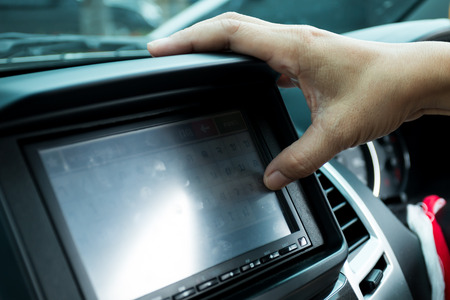 Driver entering an address into the navigation systemの写真素材