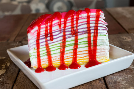 strawberry sauce on rainbow crape cakeの写真素材