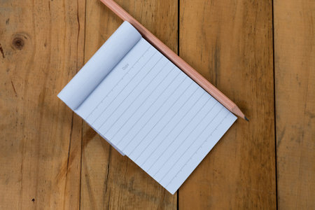 white notepad with pencil on a woodenの写真素材