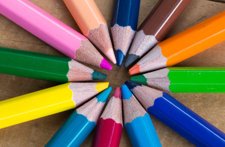 bunch of colored pencils  on wood background
