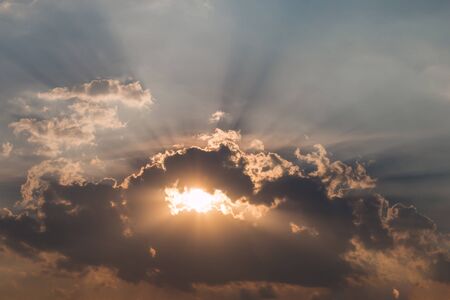 sun rays illuminate the sky above the horizonの写真素材