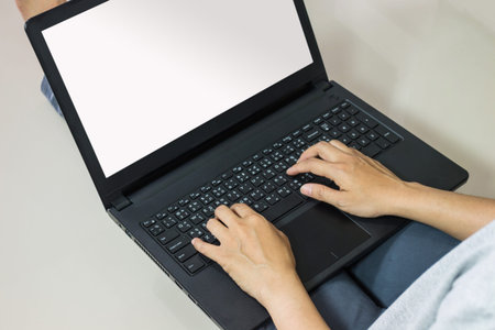Close-up Of Young Woman Using Laptop On floor