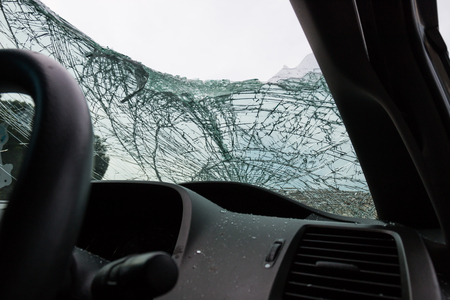 Inside the car with windshield cracks due to accident damageの写真素材
