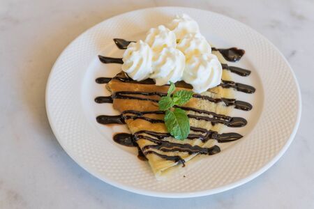 Fresh waffles with ice cream and chocolate syrupの写真素材