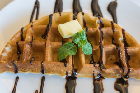 Fresh waffles with ice cream and chocolate syrupの写真素材