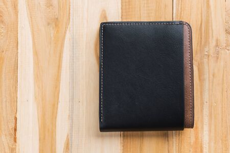 Black leather wallet on wooden backgroundの写真素材