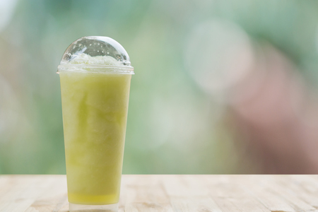 cantaloupe  juice in the glass on the wooden tableの写真素材