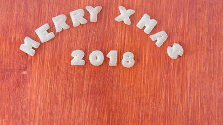Merry Christmas and Happy new year cookies on wooden background Top viewの写真素材