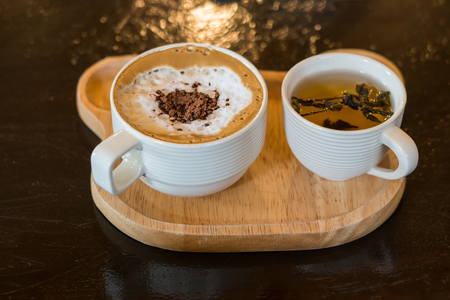 latte coffee cup and tea cup on wood tableの写真素材