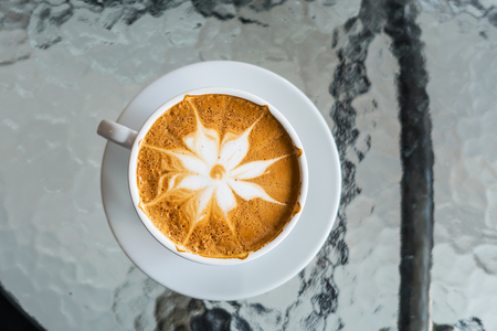 hot coffee Latte art on the wooden tableの写真素材
