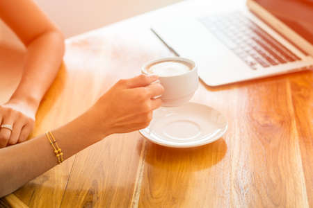 business Woman Hand Holding Coffee Cup and Workingの写真素材