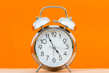 Retro alarm clock on orange backgroundの写真素材