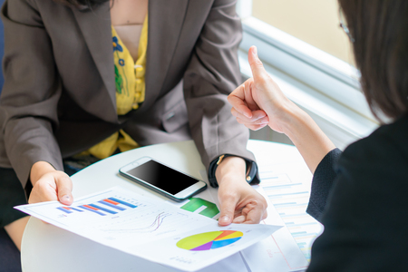 Boss employer admires young  business woman for her success and good in workの写真素材
