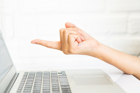 business woman pointing at laptop screen on workplaceの写真素材