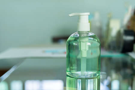 Alcohol Gel for hand washing on glass tableの写真素材