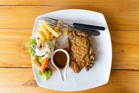 Roast Steak with baked potatoes and vegetable saladの写真素材