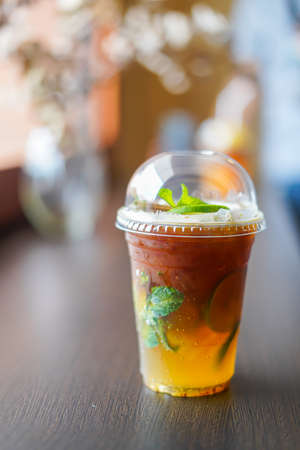 Orange Americano coffee in a take-out cupの写真素材