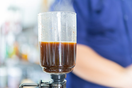 Brewing Syphon Drip Coffee on Counter in Coffee Shop in Classic Vintageの写真素材