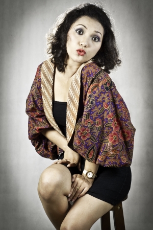 Portrait asia girl with curly hair wearing traditional regional costumes from Indonesia の写真素材