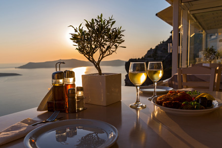 Romantic dinner for two on the island Santorini, Greece. Views of the sea and the volcanoの写真素材