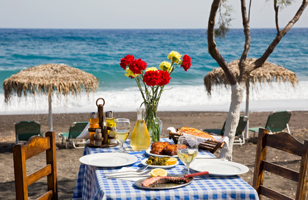 Beautiful romantic table on the beach near the seaの写真素材