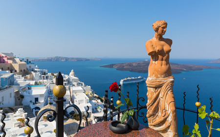 Decorative statue of Aphrodite in the background of the sea and the volcano of Santorini, Greece.の写真素材