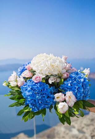 Wedding bouquet in bride hand on the background of the seaの写真素材