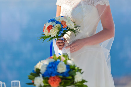Bride in white dress with bouquet of flowers. Greece, island of Santoriniの写真素材