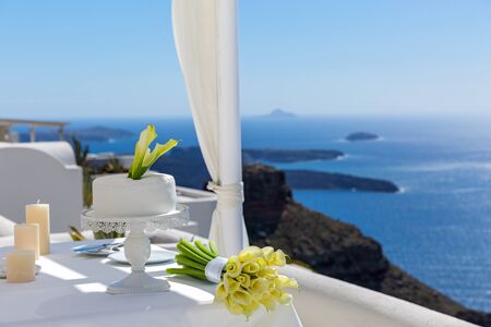 Wedding cake and a bouquet of yellow Calla liliesの写真素材