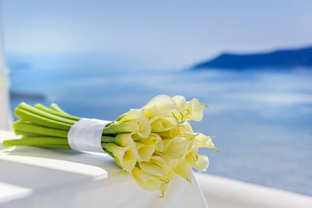 Wedding bouquet with yellow Callas lilies on the tableの写真素材