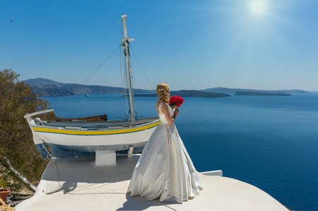 Bride in a beautiful dress on a background of island Santorini, Greeceの写真素材