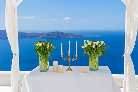 Wedding decorations with white tulips on the background of the seaの写真素材