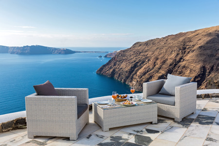 Fresh juice and Breakfast on the table, next to the coastの写真素材