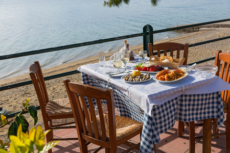 Table for dinner in a fish restaurant by the seaの写真素材