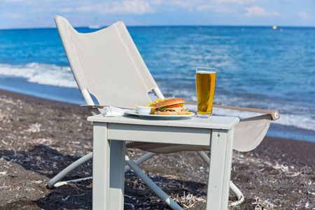 French fries and a sandwich on the beachの写真素材