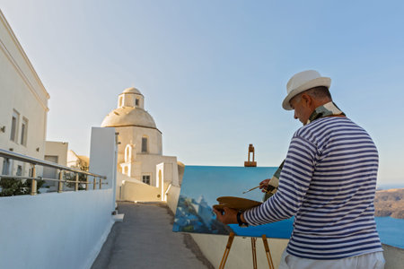 Man with the easel the sea draws and a Church Greece, Santoriniの写真素材