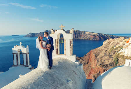 Young wedding couple on the rooftops of Santorini, Greeceの写真素材