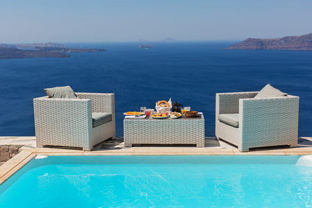 Breakfast by the pool overlooking the sea landscapeの写真素材