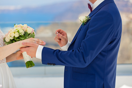 Wedding, the groom wears the ring brideの写真素材