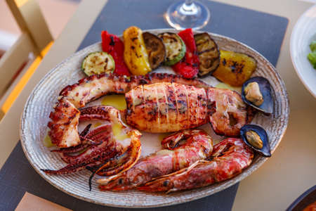 Dish with a variety of seafood on the tableの写真素材