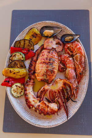 Dish with a variety of seafood on the tableの写真素材