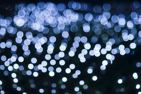 Defocused blue light dots against black background,Processed  from a 12 bit RAW files in Adobe RGB colorspace and professionally retouched to achieve the best image qualityの写真素材