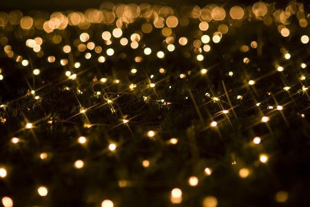 Defocused yellow light dots against black background