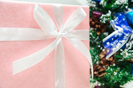 Beautiful pink gift box under a christmas tree の写真素材