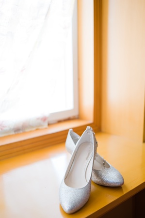 Elegant wedding shoes over windowの写真素材