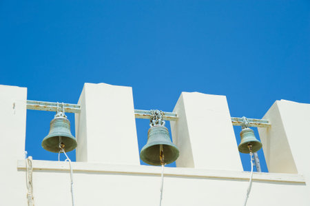 White Bell Tower against blue Sky in Greeceの写真素材