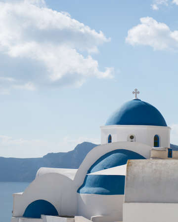 Blue dome church with bell tower in Santorini island, Greece.の写真素材
